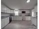 Bright kitchen featuring white cabinets, granite countertops, stainless steel appliances, and wood-look flooring at 35494 Dry Rd, Albemarle, NC 28001