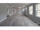 Spacious living room featuring vinyl plank flooring, neutral paint, and lots of natural light at 35494 Dry Rd, Albemarle, NC 28001