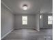 Open-concept living room with neutral paint, white trim, and vinyl plank flooring throughout at 35494 Dry Rd, Albemarle, NC 28001