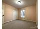 Bright carpeted bedroom has a window, closet, and light peach colored walls at 3660 9Th Street Ne Dr, Hickory, NC 28601