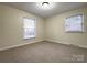 Bright bedroom featuring neutral walls, carpet flooring and two windows for natural light at 3660 9Th Street Ne Dr, Hickory, NC 28601