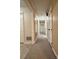 Hallway with neutral carpet, beige walls, and white doors adds a touch of elegance to the home's interior at 3660 9Th Street Ne Dr, Hickory, NC 28601