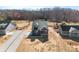 Aerial view of a blue home with a long driveway and partially cleared lot at 4005 Miller Rd, Salisbury, NC 28147