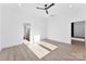 Bright bedroom boasts a ceiling fan, neutral walls, and hardwood floors, creating a modern aesthetic at 4005 Miller Rd, Salisbury, NC 28147