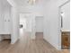 Bright entryway with light hardwood flooring and white walls leading into a large kitchen at 4005 Miller Rd, Salisbury, NC 28147