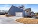 A beautiful two-story home featuring blue siding, a white garage door, and a concrete driveway at 4005 Miller Rd, Salisbury, NC 28147