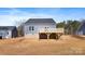 View of back of house with deck and backyard showing brick foundation at 4005 Miller Rd, Salisbury, NC 28147