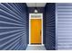 A bright yellow front door under a lit entryway with blue vinyl siding at 4005 Miller Rd, Salisbury, NC 28147