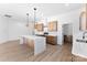 A view of the kitchen featuring an island with quartz countertops, stainless appliances, and hardwood floors at 4005 Miller Rd, Salisbury, NC 28147