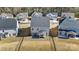 An aerial view shows the home's fenced yard, and patio with outdoor seating, nestled within a residential community at 4208 Stream Dale Nw Cir, Concord, NC 28027