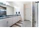 Modern bathroom with double sinks, granite countertops, and contemporary fixtures at 4208 Stream Dale Nw Cir, Concord, NC 28027