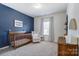 Charming Bedroom with a blue accent wall and natural wood crib at 4208 Stream Dale Nw Cir, Concord, NC 28027