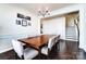 Elegant dining room featuring a large wooden table, chandelier, and wainscoting at 4208 Stream Dale Nw Cir, Concord, NC 28027