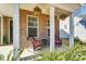 A charming front porch features cozy seating and hanging flower baskets, creating a welcoming outdoor space at 4208 Stream Dale Nw Cir, Concord, NC 28027