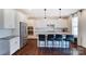 Bright kitchen features white cabinets, granite countertops, a stainless steel refrigerator, and a center island at 4208 Stream Dale Nw Cir, Concord, NC 28027