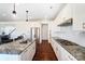 Bright kitchen features white cabinets, stainless steel appliances, granite countertops, and hardwood floors at 4208 Stream Dale Nw Cir, Concord, NC 28027