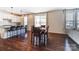 Open-concept space with hardwood floors, a kitchen island, and dining area at 4208 Stream Dale Nw Cir, Concord, NC 28027