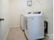 Convenient laundry room equipped with modern washer and dryer units at 4208 Stream Dale Nw Cir, Concord, NC 28027