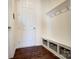 Mud room with coat hooks, storage bench, and wood look floors at 4208 Stream Dale Nw Cir, Concord, NC 28027