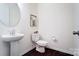 Clean powder room featuring a pedestal sink, toilet, and modern fixtures at 4208 Stream Dale Nw Cir, Concord, NC 28027