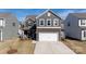 Two-story home features gray siding, stone accents, a two-car garage, and a well-maintained lawn at 446 Brannon Meadows Dr, York, SC 29745