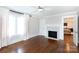 Well-lit bedroom features hardwood floors, fireplace, and ceiling fan at 4717 Doris Ave, Charlotte, NC 28205