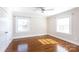 Sunlit bedroom with hardwood floors, ceiling fan, and neutral paint at 4717 Doris Ave, Charlotte, NC 28205