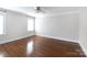 Bedroom with hardwood flooring, a ceiling fan, neutral walls and bright windows at 4717 Doris Ave, Charlotte, NC 28205