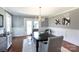 Elegant dining room featuring wainscoting, a modern chandelier, and direct access to the outdoor patio at 4717 Doris Ave, Charlotte, NC 28205