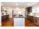 Modern kitchen with an island, stainless steel appliances, and wood floors throughout the open-concept layout at 4717 Doris Ave, Charlotte, NC 28205