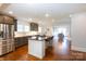 Eat-in kitchen with a center island, stainless appliances, and hardwood floors at 4717 Doris Ave, Charlotte, NC 28205