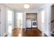 Hallway with laundry room featuring stacked washer and dryer, hardwood flooring and access to more rooms at 4717 Doris Ave, Charlotte, NC 28205