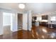 Spacious living room with hardwood floors, leading into kitchen with stainless steel appliances at 4717 Doris Ave, Charlotte, NC 28205