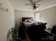 Comfortable bedroom featuring a ceiling fan, a large bed, and neutral-colored walls at 5009 Oak Pasture Ln, Charlotte, NC 28269