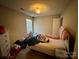 Bedroom with tan walls, double bed, and natural light from the window at 5009 Oak Pasture Ln, Charlotte, NC 28269