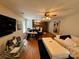 Spacious living room featuring wood floors, a modern sofa, and ample natural light at 5009 Oak Pasture Ln, Charlotte, NC 28269