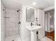 Modern bathroom featuring white tiles, black fixtures and a stylish pedestal sink at 507 N Oakland St, Gastonia, NC 28052