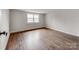 Bedroom features warm, natural light from window and gleaming hardwood floors at 507 N Oakland St, Gastonia, NC 28052