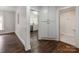 Hallway view to kitchen and bathroom, featuring hardwood floors and white trim at 507 N Oakland St, Gastonia, NC 28052