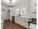 Well-lit kitchen features hardwood floors, bright white cabinets, and stainless steel appliances at 507 N Oakland St, Gastonia, NC 28052