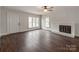 Bright living room featuring hardwood floors, a fireplace, and lots of natural light at 507 N Oakland St, Gastonia, NC 28052