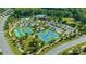 An aerial view of community tennis courts and a pool, surrounded by lush trees and convenient parking at 5136 Samoa Ridge Dr, Lancaster, SC 29720