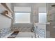 Luxurious bathroom featuring a soaking tub with stylish tile accents, floating shelves, and a sleek faucet at 5136 Samoa Ridge Dr, Lancaster, SC 29720