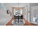 Cozy breakfast nook with a round table, modern chandelier, and hardwood floors, bathed in natural light at 5136 Samoa Ridge Dr, Lancaster, SC 29720