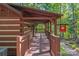 Covered porch of log cabin-style building with signage, providing shade and a welcoming entrance at 5136 Samoa Ridge Dr, Lancaster, SC 29720