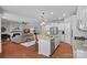 Open kitchen featuring white cabinets, granite countertops, a large island and view of the living area at 5136 Samoa Ridge Dr, Lancaster, SC 29720