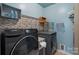 Well-organized laundry room features a modern washer and dryer with custom shelving and decorative touches at 5136 Samoa Ridge Dr, Lancaster, SC 29720