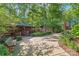 Outdoor gathering space featuring benches, picnic tables, and log cabins in a beautifully landscaped setting at 5136 Samoa Ridge Dr, Lancaster, SC 29720