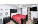 Well-lit bedroom features a large bed with red coverlet, black furniture, and neutral walls at 625 Circle Trace Rd, Monroe, NC 28110