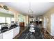 Bright, open kitchen features black granite countertops, white cabinets and modern light fixtures at 625 Circle Trace Rd, Monroe, NC 28110